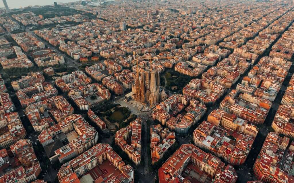 Aerial view of the Sagrada Família rising from Barcelona's Eixample street grid